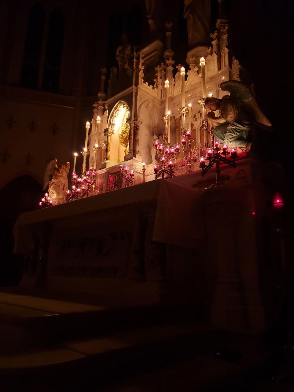 Candles lit at the altar during evening adoration
